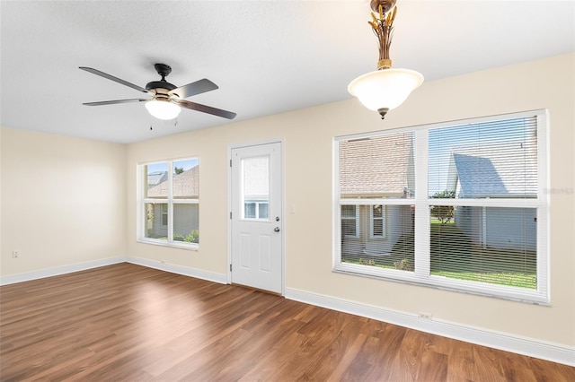 entryway with ceiling fan and dark hardwood / wood-style flooring