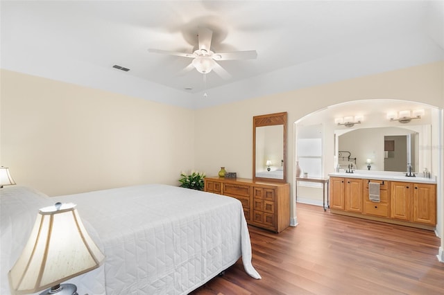 bedroom with dark hardwood / wood-style flooring, sink, and ceiling fan