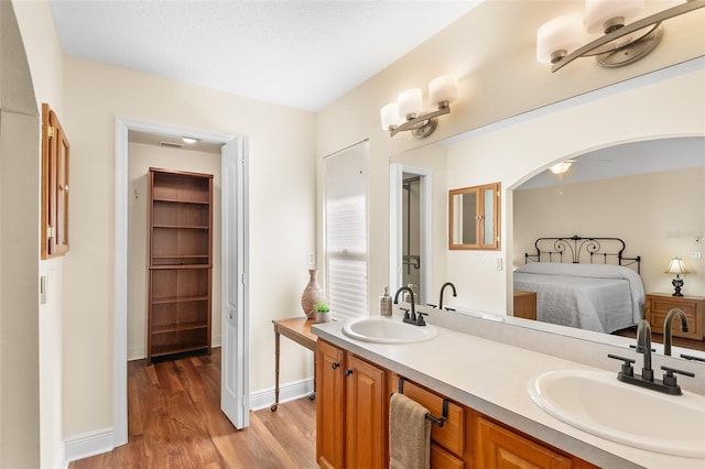 bathroom with ceiling fan, wood-type flooring, and vanity