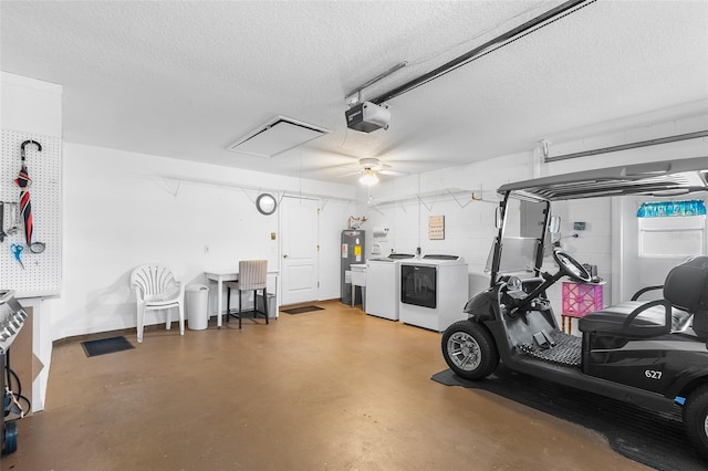 garage featuring a garage door opener, washing machine and dryer, and electric water heater