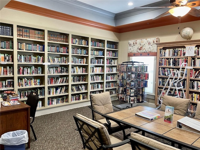 carpeted office space featuring ceiling fan and ornamental molding