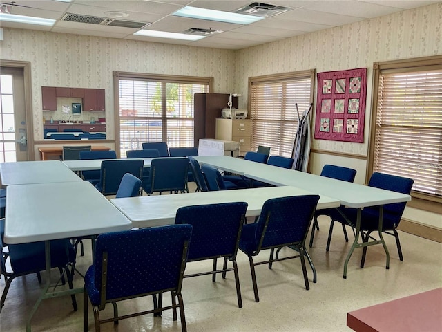 dining space with a paneled ceiling