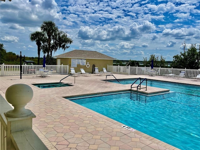 view of pool featuring a patio and a community hot tub