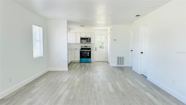 unfurnished living room featuring light wood-type flooring