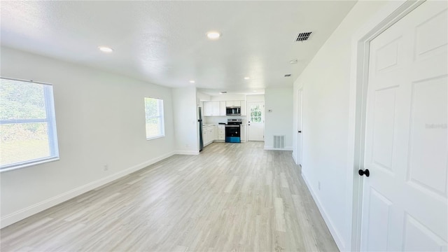 unfurnished living room with light wood-type flooring