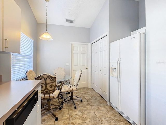 kitchen with white appliances, light tile patterned flooring, and a textured ceiling