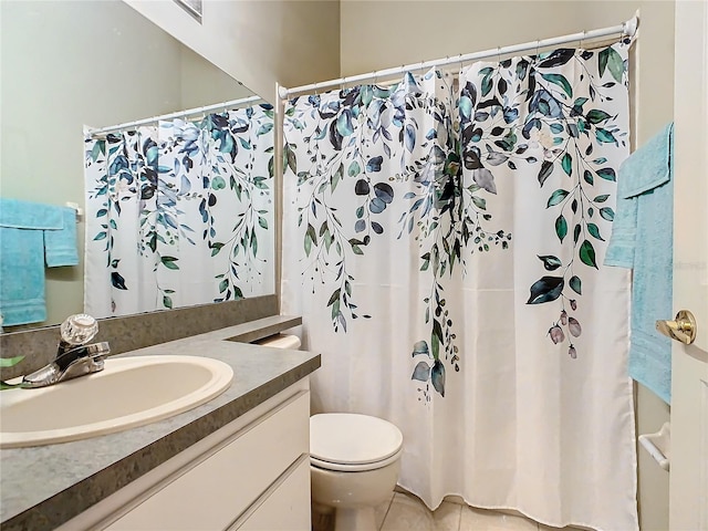 bathroom with toilet, tile patterned floors, and vanity