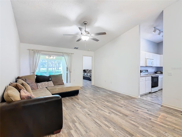 living room with ceiling fan, light hardwood / wood-style flooring, and lofted ceiling