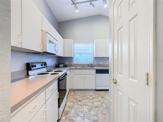 kitchen with sink, white appliances, white cabinets, and light tile patterned floors