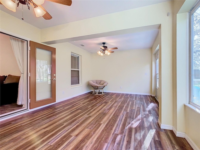 unfurnished sunroom with ceiling fan