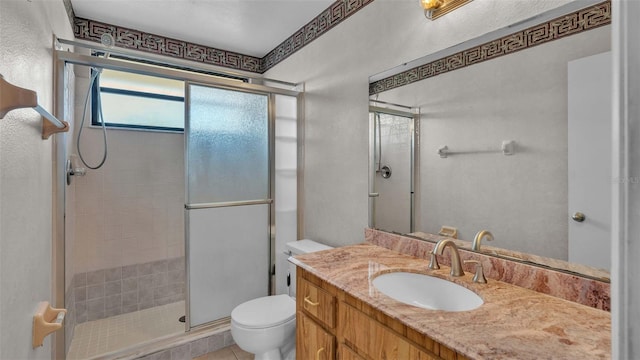 bathroom with vanity, tile patterned floors, toilet, and walk in shower