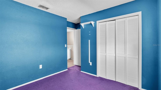 unfurnished bedroom with a textured ceiling and a closet