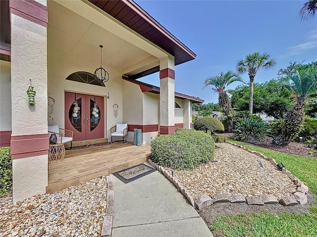 property entrance with french doors and stucco siding