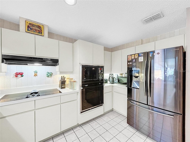 kitchen with visible vents, under cabinet range hood, light countertops, a textured ceiling, and black appliances