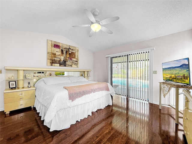 bedroom with access to exterior, dark wood-type flooring, vaulted ceiling, a textured ceiling, and ceiling fan