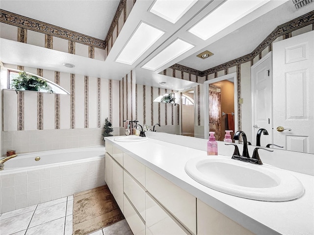 full bathroom featuring double vanity, a garden tub, a sink, and wallpapered walls