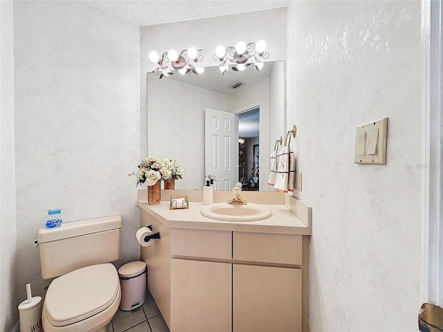 bathroom featuring a textured ceiling, toilet, visible vents, vanity, and tile patterned floors