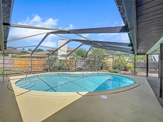 view of pool with a patio area, a fenced backyard, a fenced in pool, and a lanai