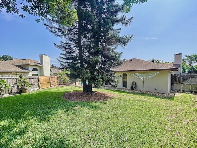 view of yard with a fenced backyard