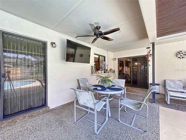 view of patio featuring outdoor dining area and a ceiling fan