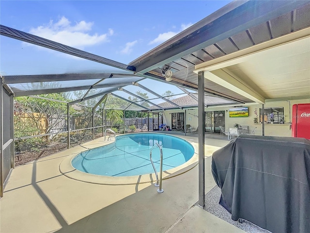 view of pool with a patio area and a lanai