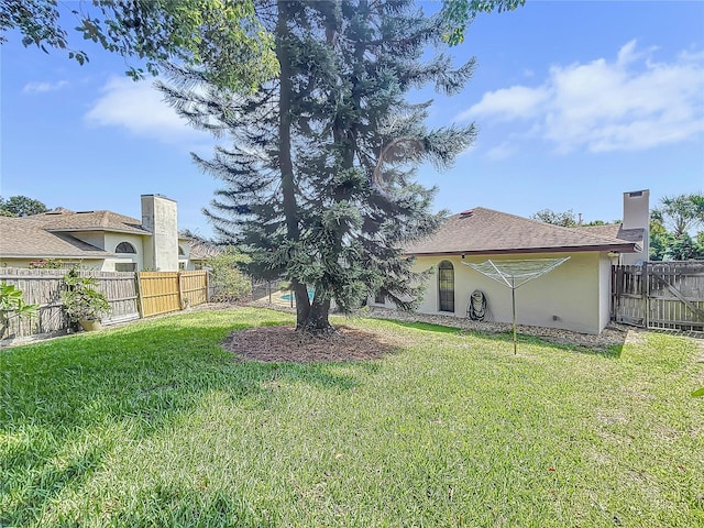 view of yard with a fenced backyard