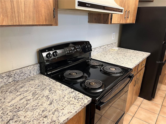 kitchen featuring black appliances, light stone counters, custom exhaust hood, and light tile patterned floors