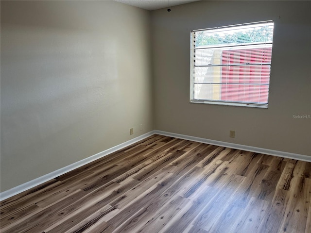 spare room with dark hardwood / wood-style floors