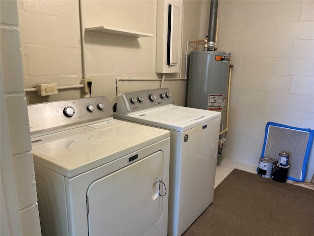 clothes washing area with gas water heater and independent washer and dryer