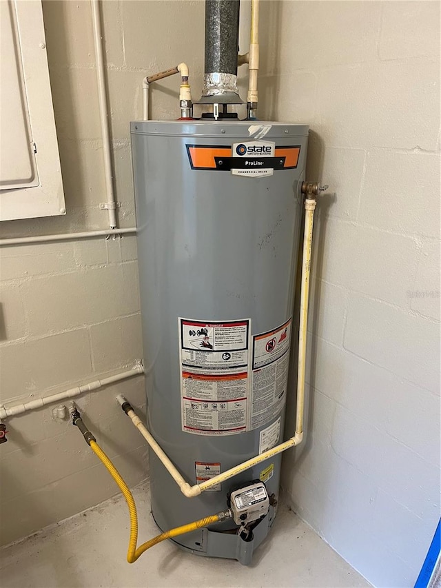 utility room featuring water heater and electric panel