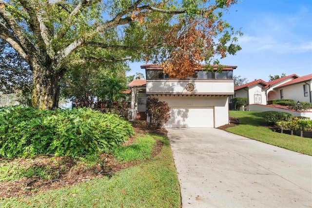 view of front of house with a garage and a front lawn