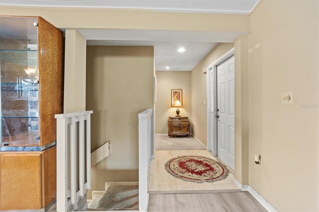 corridor with light hardwood / wood-style floors