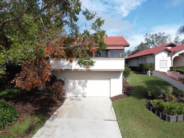 view of front of property featuring a garage and a front yard