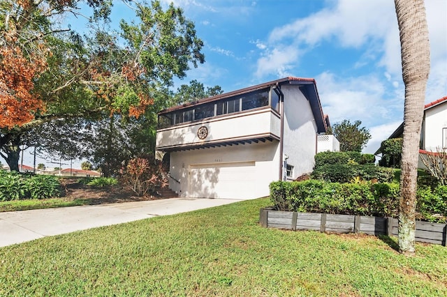 view of front of property with a garage and a front yard