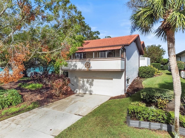 view of front facade with a garage and a front yard