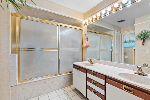 bathroom featuring tile patterned flooring, vanity, and enclosed tub / shower combo