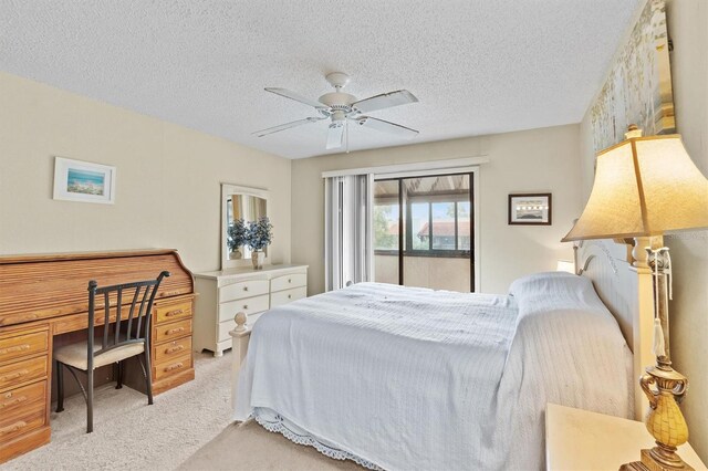 bedroom featuring ceiling fan, light colored carpet, a textured ceiling, and access to outside