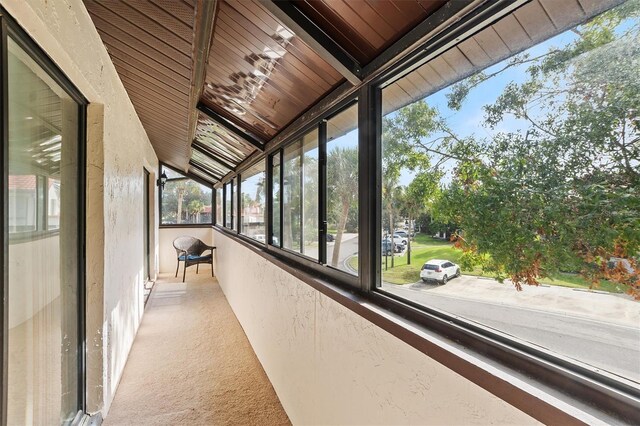 unfurnished sunroom with wood ceiling