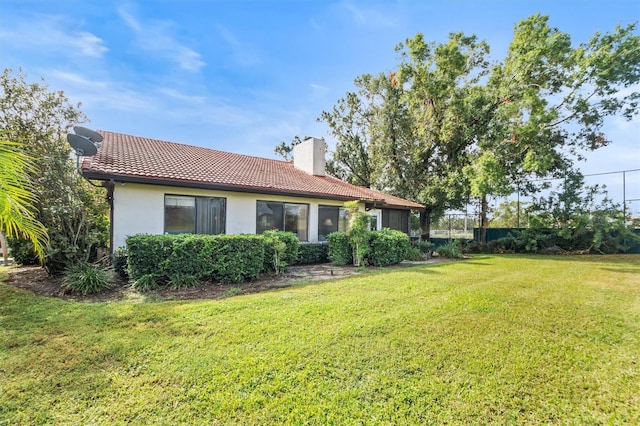 rear view of house with a lawn