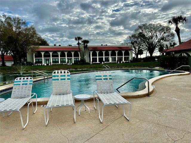 view of swimming pool with a patio area