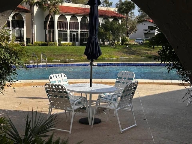 view of swimming pool featuring a yard and a patio area