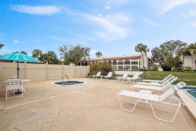 view of patio with an in ground hot tub