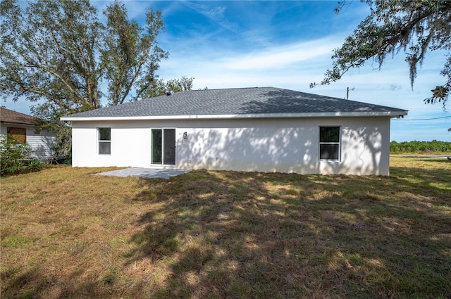 rear view of property with a patio area and a yard