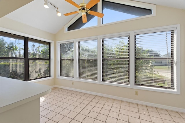 unfurnished sunroom featuring lofted ceiling, ceiling fan, and plenty of natural light