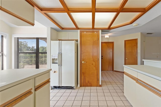 kitchen featuring coffered ceiling, white refrigerator with ice dispenser, and light tile patterned floors