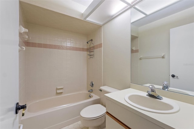 full bathroom featuring toilet, tiled shower / bath, vanity, and tile patterned floors