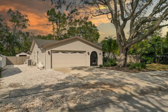 view of front of property with central air condition unit and a garage