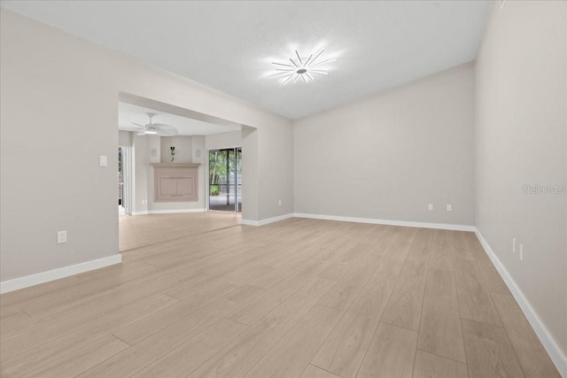 empty room featuring light hardwood / wood-style floors and ceiling fan