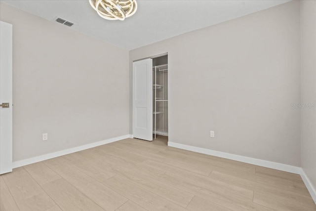 unfurnished room with light hardwood / wood-style floors