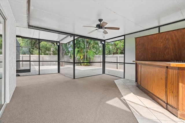 unfurnished sunroom with ceiling fan